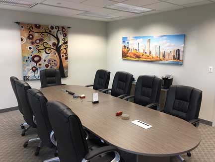 10-person conference room at Lake Cook Reporting facing our panoramic Chicago skyline and tapestry.